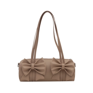 Pink cylinder cloud bag with stylish double bow accents and dual shoulder straps