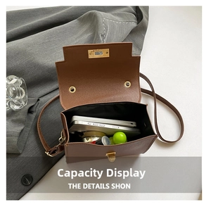 Internal view of brown leather bag showing storage capacity for phone and makeup