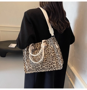 Detail view of leopard print canvas tote with side pocket and reinforced white strap