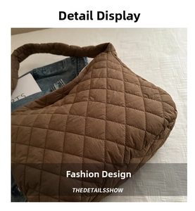 Close-up of brown quilted cloud tote bag featuring soft pleated texture and wide handle