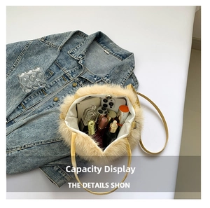 Spacious interior of plush crossbody bag showing storage for phone and perfume