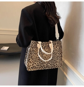 Detail of leopard print canvas tote bag showing wide shoulder strap and spacious design