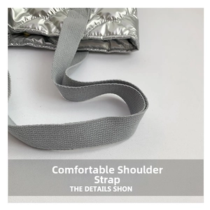 Détail du sac cabas matelassé argenté avec large bandoulière grise en nylon tissé robuste