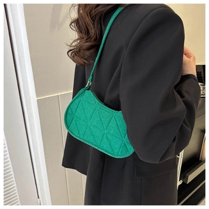 Close-up of vibrant green quilted felt hobo bag showing texture and stitching details