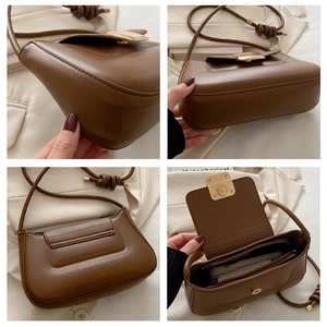 Detailed view of brown leather bag showing gold hardware, bottom, side and inner pocket