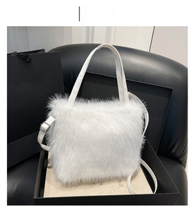 Detailed close-up of white fluffy faux fur tote bag with matching straps in a gift box
