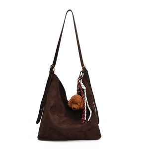 Large dark brown suede hobo bag with adjustable strap and decorative plush charms