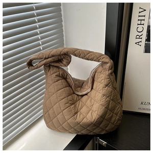 Detailed view of brown quilted crossbody bag with rhombus embroidery and padded nylon texture