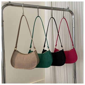 Detail of felt underarm bags with triangle stitching and metallic hardware in four colors