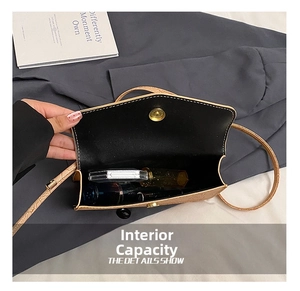 Detail view of brown crocodile texture crossbody bag showing internal storage capacity