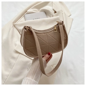 Detail of camel felt shoulder bag with geometric triangle quilting and gold zipper