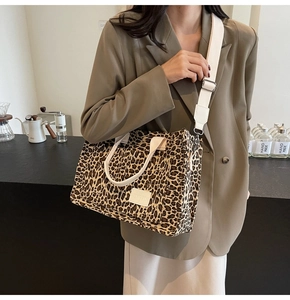 Detail of leopard print canvas tote bag featuring adjustable strap and JINGPIN patch