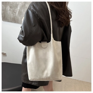 Minimalist matte grey bucket bag shown with a model for a stylish daily commute