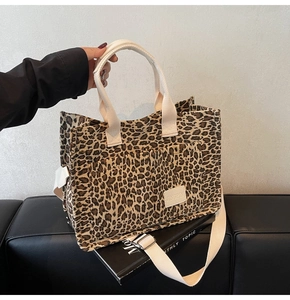 Detail of leopard print canvas tote bag with front pockets and adjustable strap