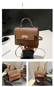 Detail view of brown leather crossbody bag with golden clasp and adjustable strap