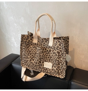 Leopard print canvas tote bag detail featuring double front pockets and woven handles