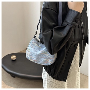 Détail du sac à bandoulière en jacquard bleu clair avec broderies vagues colorées