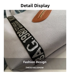 Détail de la texture toile gris clair avec garniture en cuir orange et fermeture