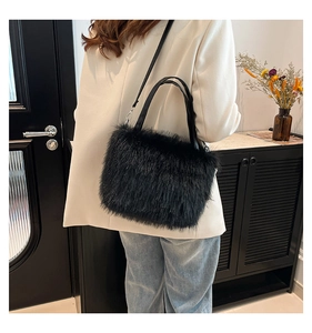 Detailed shot of black faux fur tote bag featuring plush texture and leather straps