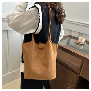 Retro camel suede tote bag shown on shoulder for a minimalist professional commute style