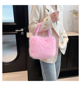 Detail of a soft pink faux fur tote bag with a matching leather handle and fluffy texture