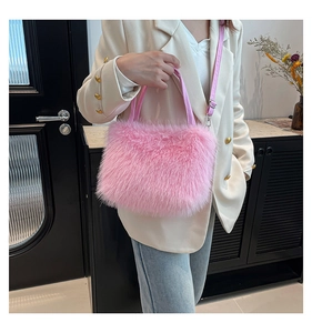 Detail of pink faux fur handbag with leather handle and silver metal hardware