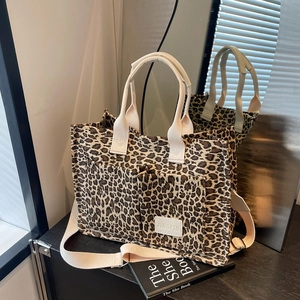 Leopard print canvas tote bag with adjustable strap and front pockets for daily commute