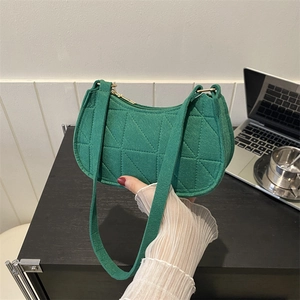Green felt fabric half-moon underarm bag with geometric quilting and gold zipper