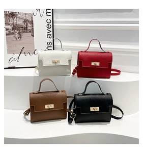 Four mini leather handbags in white, red, brown, and black displayed on white steps