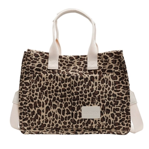 Leopard print canvas tote bag with double front pockets and shoulder straps on white background