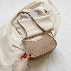 Quilted felt baguette shoulder bag in beige featuring geometric patterns and minimalist style