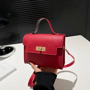 Classic red cross-grain leather crossbody bag with gold twist lock and top handle