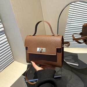 Brown lychee leather crossbody bag with silver twist lock and wide top handle