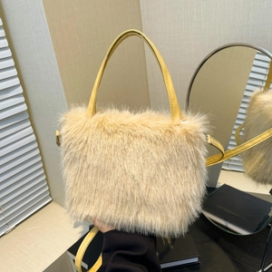 Beige faux fur tote bag with leather handles in a cozy minimalist indoor setting
