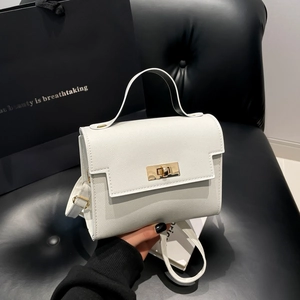 White faux leather crossbody bag with gold turn-lock closure and elegant top handle