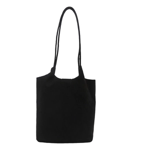 Minimalist black suede tote bag with double shoulder straps and magnetic flap closure