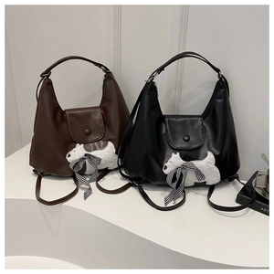 Retro half-moon crossbody bag in brown and black leather with plush dog patch