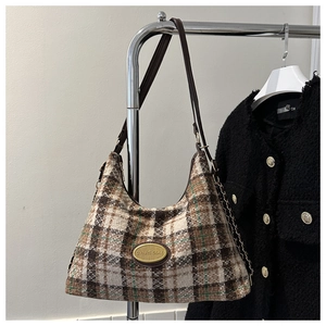 Dettaglio della trama in tweed vintage e logo in metallo sulla borsa tote grande