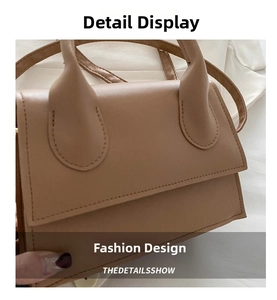 Detailed macro view of the minimalist light brown leather texture and flap on the handbag