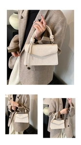 Detail of off-white crossbody bag with floral lace texture and knotted handle