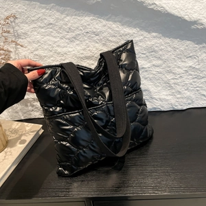 Chic black quilted down tote bag for women featuring a spacious and minimalist winter design