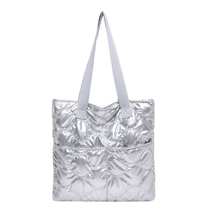 Silver quilted tote bag with metallic texture and spacious minimalist design for women