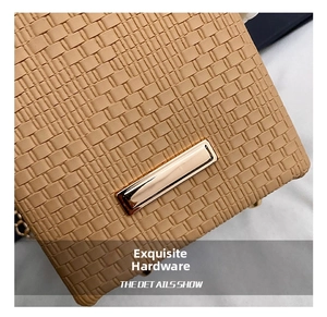 Close-up of woven leather texture and polished gold hardware on a bucket bag
