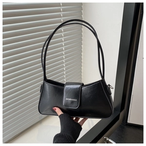 Close-up of black leather underarm bag featuring sleek metal buckle and branding detail