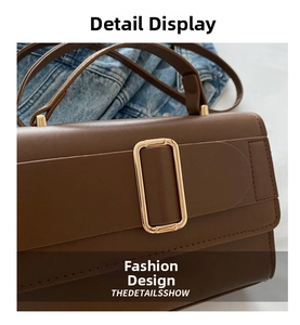 Detail of dark brown leather handbag featuring a large gold square buckle and neat stitching