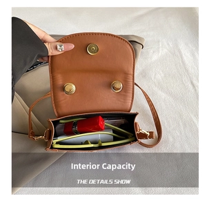Top view of saddle bag interior showing storage space for sunglasses and lipstick