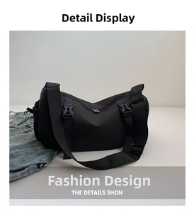 Detail shot of the black waterproof nylon fabric and durable plastic buckles on the bag