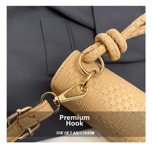 Detail showing the beige woven PU leather texture and premium gold lobster clasp hook