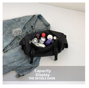 Internal storage detail of black nylon crossbody bag showing spacious capacity and items