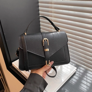 Chic black litchi pattern crossbody bag with golden hardware and top handle for women